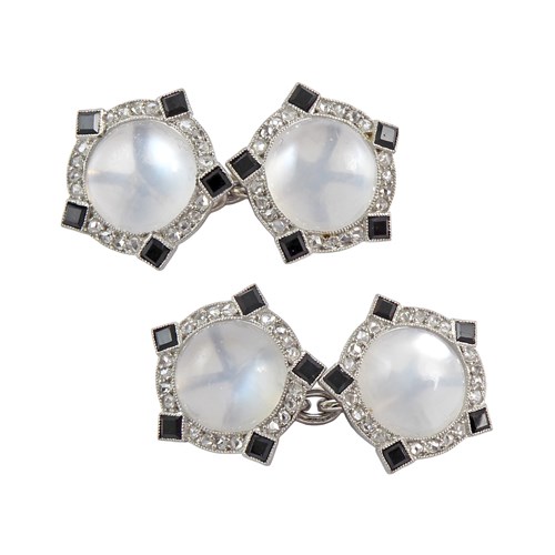 Pair of Art Deco cabochon moonstone, diamond and onyx cufflinks by Cartier c.1925, of stylised Tudor rose design,